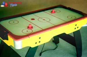 What is the surface of an air hockey table made of